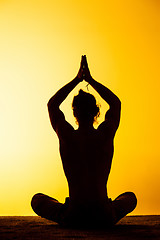 Image showing The man practicing yoga in the sunset light