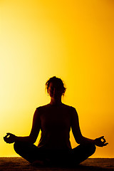 Image showing The woman practicing yoga in the sunset light