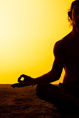 Image showing The man practicing yoga in the sunset light