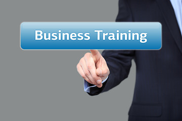 Image showing technology, internet and networking concept - businessman pressing business training button on virtual screens