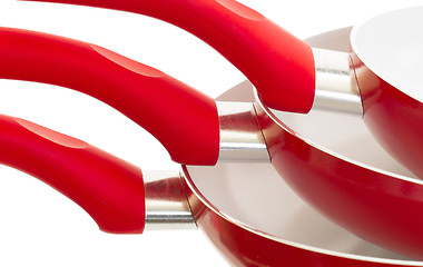 Image showing Set of three frying pans, red