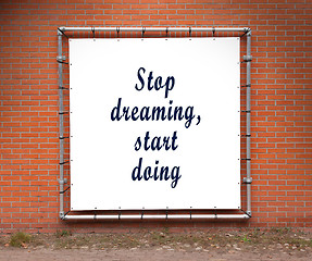 Image showing Large banner with inspirational quote on a brick wall