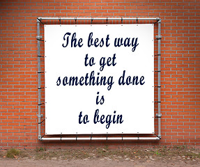 Image showing Large banner with inspirational quote on a brick wall