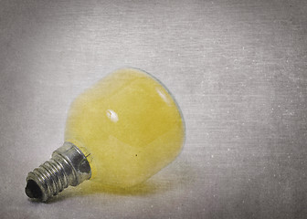 Image showing Old yellow lightbulb isolated on a white background