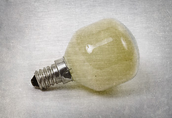 Image showing Old yellow lightbulb isolated on a white background