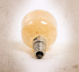 Image showing Old orange lightbulb isolated on a white background