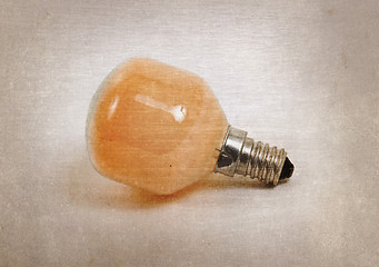 Image showing Old orange lightbulb isolated on a white background