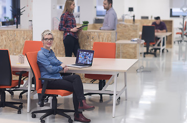 Image showing portrait of young business woman at office with team in backgrou