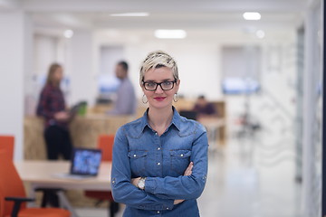 Image showing portrait of young business woman at office with team in backgrou