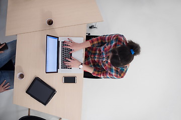 Image showing top view of young business woman working on laptop