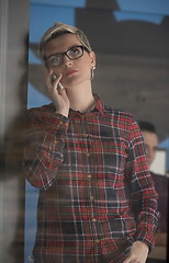 Image showing business woman in meeting room  speaking by cell phone