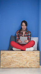 Image showing woman in crative box working on tablet