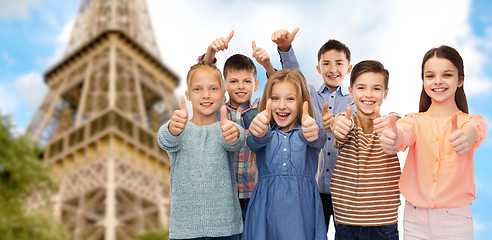Image showing happy children showing thumbs up over eiffel tower