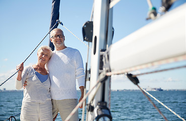 Image showing senior couple hugging on sail boat or yacht in sea