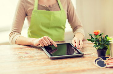 Image showing close up of woman or gardener with tablet pc