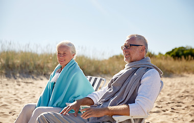 Image showing happy senior couple in chairs on summer beach