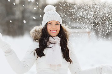 Image showing happy woman with snow outdoors in winter
