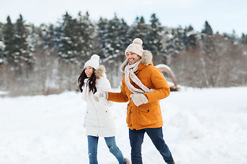 Image showing happy couple running over winter background