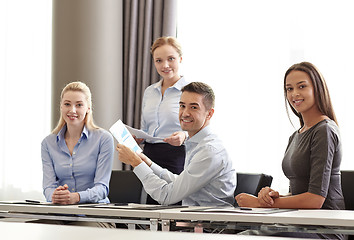 Image showing smiling business people with papers in office