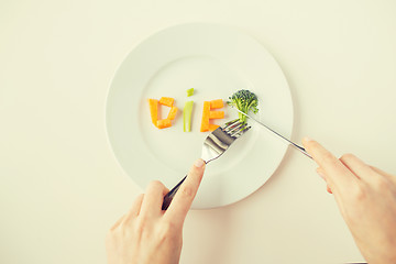 Image showing close up of woman hands eating vegetables