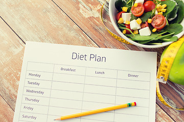 Image showing close up of diet plan and food on table