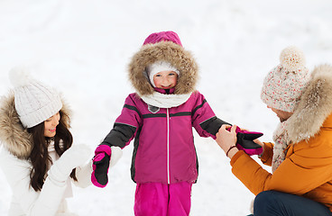 Image showing happy family with child in winter clothes outdoors