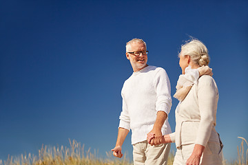 Image showing happy senior couple talking outdoors