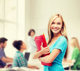 Image showing smiling student with folders