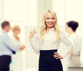 Image showing smiling businesswoman or secretary in office