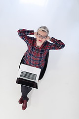 Image showing top view of young business woman working on laptop computer