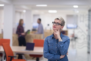 Image showing portrait of young business woman at office with team in backgrou