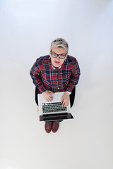 Image showing top view of young business woman working on laptop computer