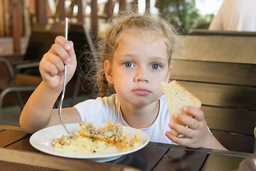 Image showing Four-year girl has lunch at an outdoor cafe