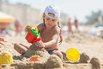 Image showing Four-year girl playing in the sand on beach seaside