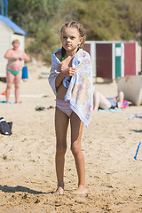 Image showing Frozen Wet Girl basking on the beach cover with a towel