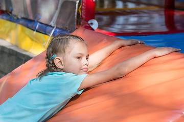 Image showing Six-year girl lies on a soft mat in front of the childrens room