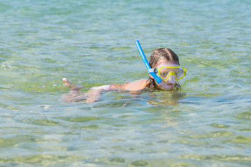 Image showing Girl floats over the water with mask and snorkel