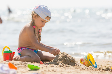 Image showing The girl on the beach seaside playing in the sand