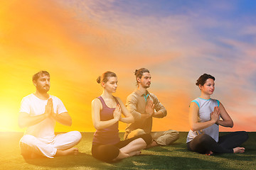 Image showing The group of people doing yoga exercises 