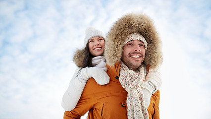 Image showing happy couple having fun over winter background