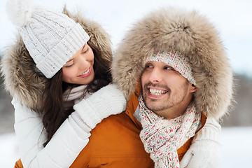 Image showing happy couple having fun over winter background