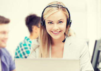 Image showing helpline operator with headphones in call centre