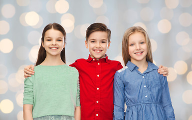 Image showing happy boy and girls hugging