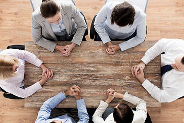 Image showing close up of business team sitting at table