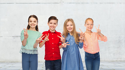 Image showing happy boy and girls showing peace hand sign