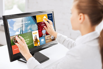 Image showing woman with web pages on touchscreen in office