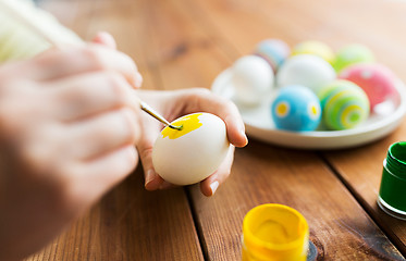 Image showing close up of woman hands coloring easter eggs