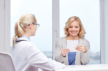 Image showing doctor giving prescription to woman at hospital