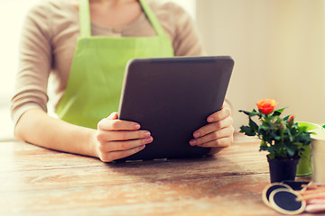 Image showing close up of woman or gardener holding tablet pc