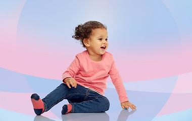 Image showing smiling little baby girl sitting on floor